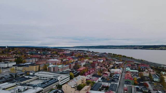 Drone Flying Above Urban Landscape Of Ostersund In Jamtland, Sweden With Storsjon Lake In Background - aerial