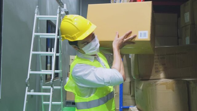 Asian male worker wearing face mask, working with new normal lifestyle