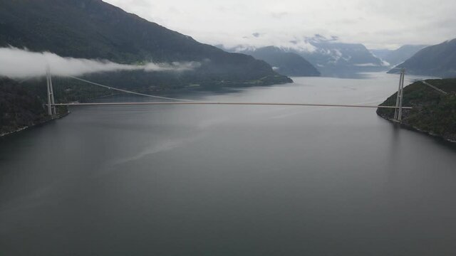 A scenic view of Hardanger bridge over  a fjord. Areal footage, Western Norway 