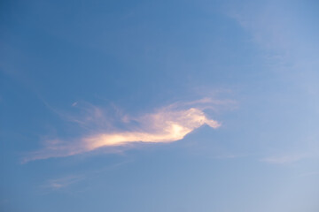 Naklejka na ściany i meble Orange clouds in the blue sky.Shapeless clouds