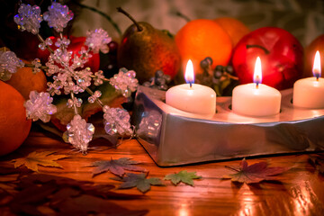 Christmas decorations with candles, fruits and snowflake