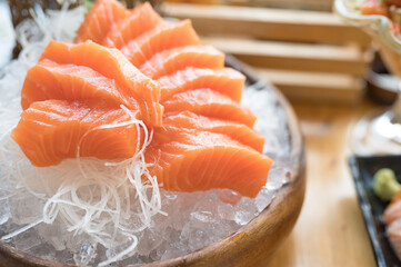 A set of sushi on a wooden table in a Japanese restaurant.Fresh salmon sliced for sushi menu.