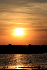 sunset over a pond out in the country north of Hutchinson Kansas USA.