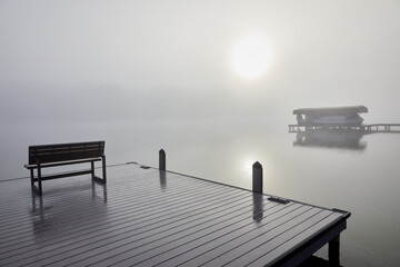 Fog so thick on the dock of the bay that you can barely see the boat close by and the image...