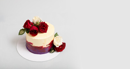 White, Red, Purple and gold edible foil cake with fresh red and white roses