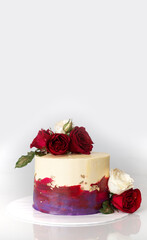 White, Red, Purple and gold edible foil cake with fresh red and white roses