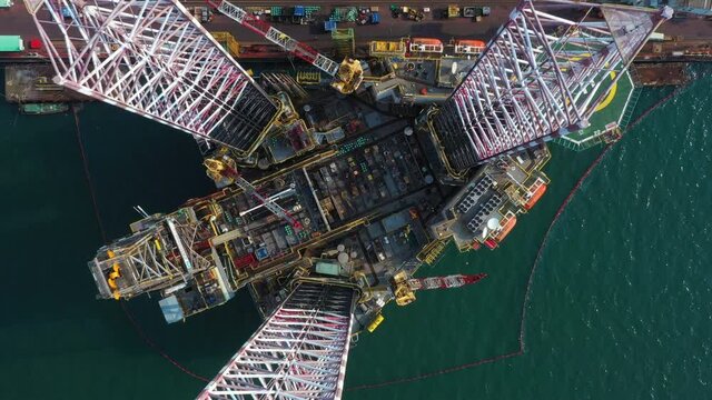 Aerial view maintenance repair of the jack up oil and gas rig up in the shipyard, Offshore oil and Gas processing platform, oil and gas industry.