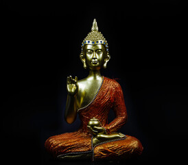 Gold buddha isolate on black background.