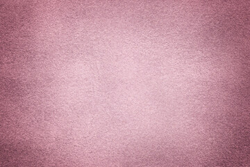 Purple matte background of suede fabric with vignette, closeup. Velvet textile.