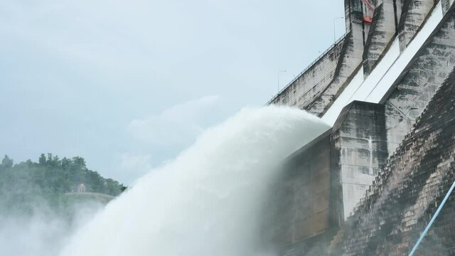 Floodgate with flowing water through gate. Open the springway Khun Dan Prakan Chon Dam thailand. Slow Motion