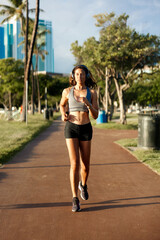 Female Runner Jogging during Outdoor Workout in a Park
