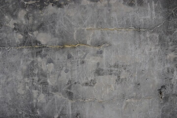 A background grunge stone concrete wall with slight graffiti detail