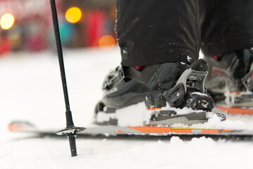 Fototapeta premium ski boots and skis at the resort, close-up, on a snowy day