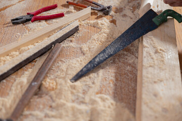 PICTURE OF A DESK WITH CARPENTING TOOLS AND DUST 	