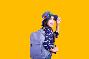 Asian woman tourist was running her to various places.happy excited emotional young woman photographer tourist standing isolated over Orange background