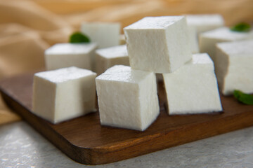 Diced Paneer or cottage cheese with green leaves. 	