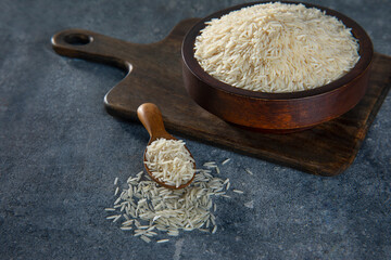 Uncooked Rice in a wooden bowl	