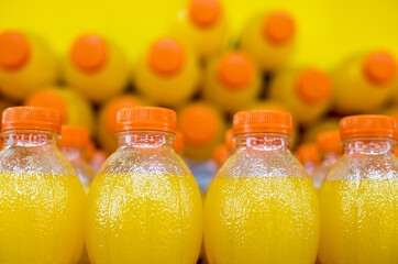 Bottles of orange juice on the shelf in the store. Refreshment. Products in the store. Delicious juice. Selling juice.