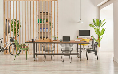 Modern and decorative office interior style with wooden long table, black metal chair, computer and laptop style.