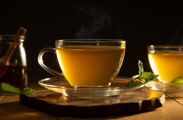 green tea with mint leaf on wooden table	