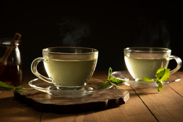 green tea with mint leaf on wooden table	