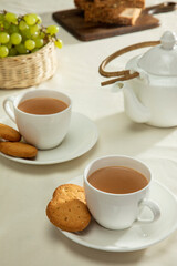 Tea cups and tasty cookies at breakfast	