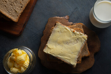 Top view of Bread and butter with a glass of milk	