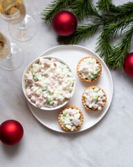 Traditional Russian salad Olivier in tartlets and Christmas decorations