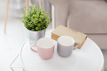 Morning tea near a window. Two cups on white table. Beautiful morning