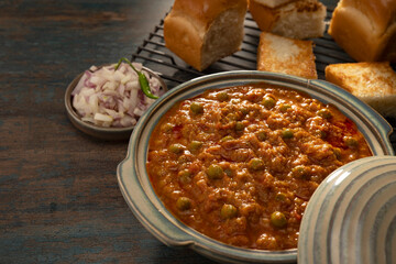 A BOWL OF BHAJI CURRY SERVED HOT WITH GRILLED PAVS	