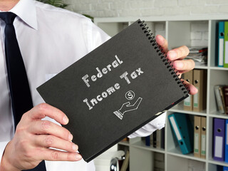 Financial concept about Federal Income Tax with inscription on the piece of paper.