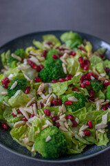healthy tasty Broccoli salad with pomegranate on a table