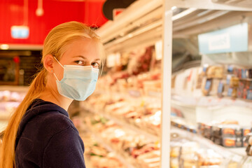 Wearing face masks in shopping centres are compulsory in Greater Sydney NSW. A girl wearing...