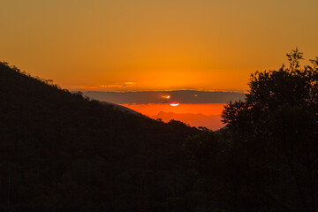 orange sky during sunset in the mountains between Teresopolis and Petropolis in the State of Rio de Janeiro in Brazil