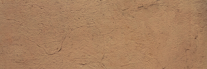 Texture of an old painted wall. Rough surface of the plastered and colored wall. Wide panoramic background for design.