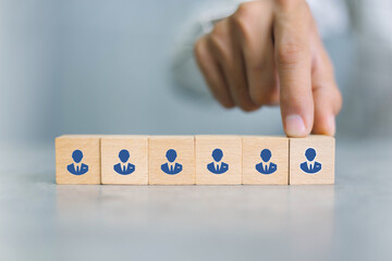 Concept of human resource management and recruitment business Hand put wood cube block on top pyramid To business success concept.