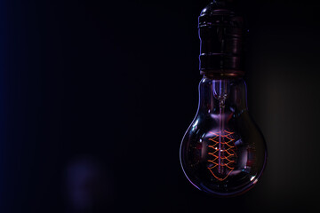 Close up of a non-burning lamp on a blurred dark background.