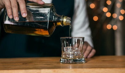 Barman pouring whiskey whiskey glass beautiful night