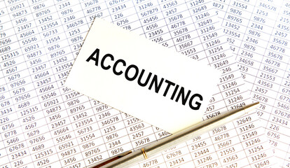 Obraz premium On the card the text of ACCOUNTING, next to the pen, the background are reports.