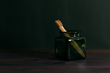 Bamboo toothbrush in glass green jar. Zero waste. recyclable
