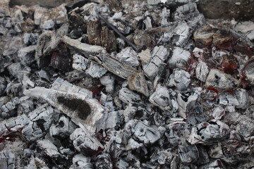 Ash embers close-up black and white grey with red weekend barbecue holiday background