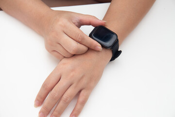 Top shot of female hand using smart watch for checking notifications 