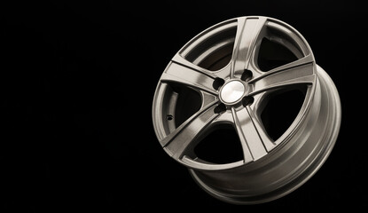 aluminum gray alloy wheel on black background, copyspace