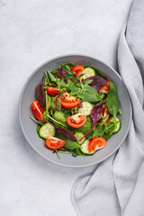 Healthy fresh salad of vegetable cucumber, tomato, spinach, arugula
