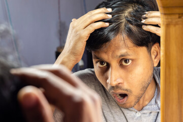 man looking at mirror