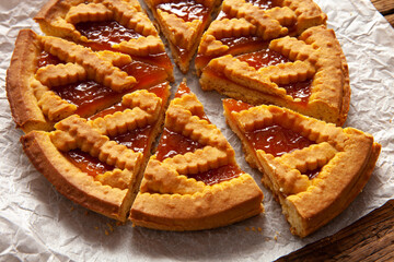 detail of sliced apricot tart over wooden table