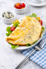 Fried eggs with cheese, cherry tomatoes and fresh lettuce.