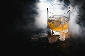 whiskey with ice on black background with smoke