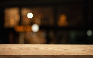 empty table on dark background with blurred lamps, cafe restaurant bokeh for your product or customization