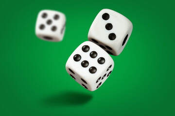  White playing dice cubes in motion on the green surface, selective focus
